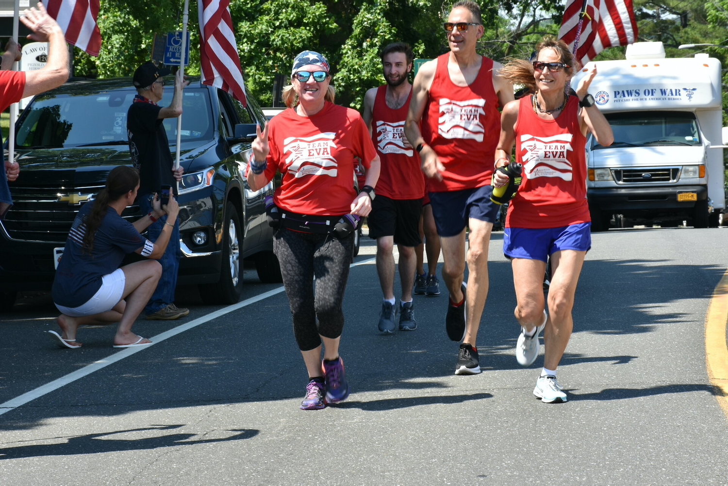 Ultramarathon runner Eva Casale (pictured waving on right), with the support of her Team E.V.A., will be completing seven marathons (over 184 miles) in seven days to raise funds and awareness to support veterans. 